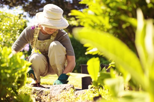 Gardener finishing pruning a hedge during a site visit